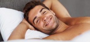 man lying in bed thinking about realboystoys